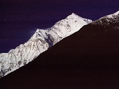 203 Dhaulagiri Ridge Closer From before Tukuche After 50 minutes from Marpha, I rounded a bend in the trail, and ahead was the long white ridge leading to Dhaulagiri resplendent in the early morning sun. (Couzy) 
